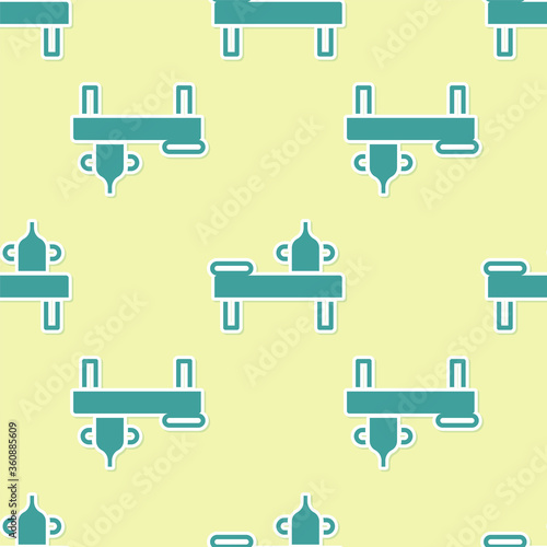 Green Massage table with oil icon isolated seamless pattern on yellow background. Vector.