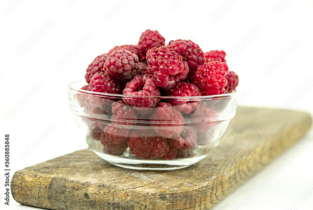 fresh ripe raspberry in a glass transparent bowl on white background fresh ripe raspberry in a glass transparent bowl on white background