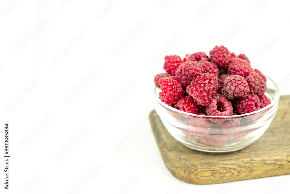 fresh ripe raspberry in a glass transparent bowl on white background fresh ripe raspberry in a glass transparent bowl on white background