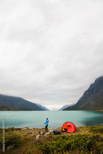 A woman camping near a lake ,in the heart of Jotunheimen, Norway