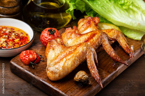 Delicious grilled chicken wings and vegetable salad