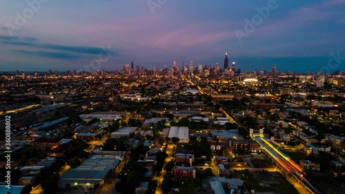 wide angle 4k aerial drone hyper lapse of the Chicago downtown metropolitan area. its evening approaching night and the city lights are illuminating the sky 