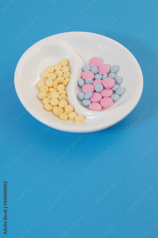 colored pills on a plate top view vertical photo colored pills on a plate top view vertical photo