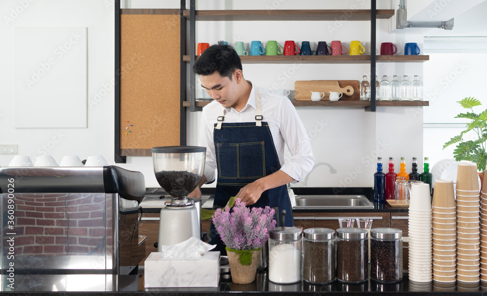 young asian man using coffee maker to brew expresso in the cafe. barista and coffee shop concept young asian man using coffee maker to brew expresso in the cafe. barista and coffee shop concept