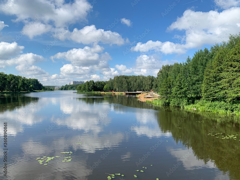 Moscow region, the city of Balashikha. Clouds over Pekhorka river in summer day