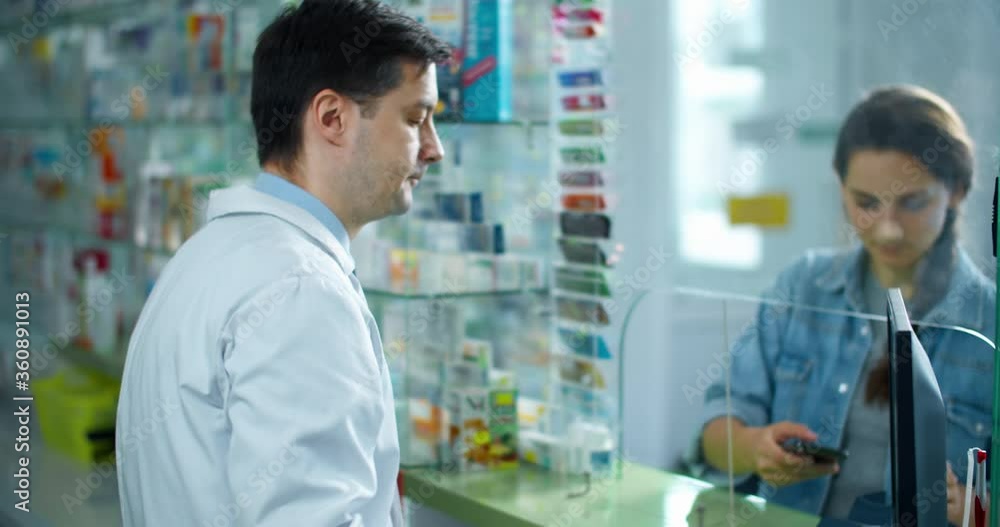 pharmacist man advises the buyer. pharmacist and a woman buyer are in a pharmacy, a pharmacist sells her medicine. Buyer Settle Through Phone pharmacist man advises the buyer. pharmacist and a woman buyer are in a pharmacy, a pharmacist sells her medicine. Buyer Settle Through Phone
