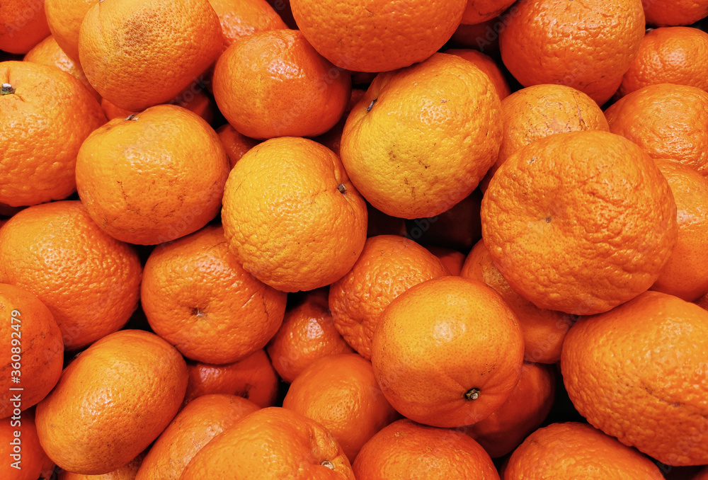 Many fresh mandarin orange. Put up for sale on the market. Many fresh mandarin orange. Put up for sale on the market.