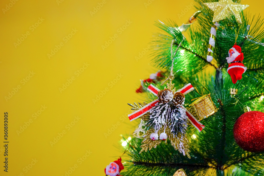 Christmas tree close up on yellow background. Christmas tree close up on yellow background.