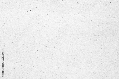 White paper or cardboard texture with black spot background.