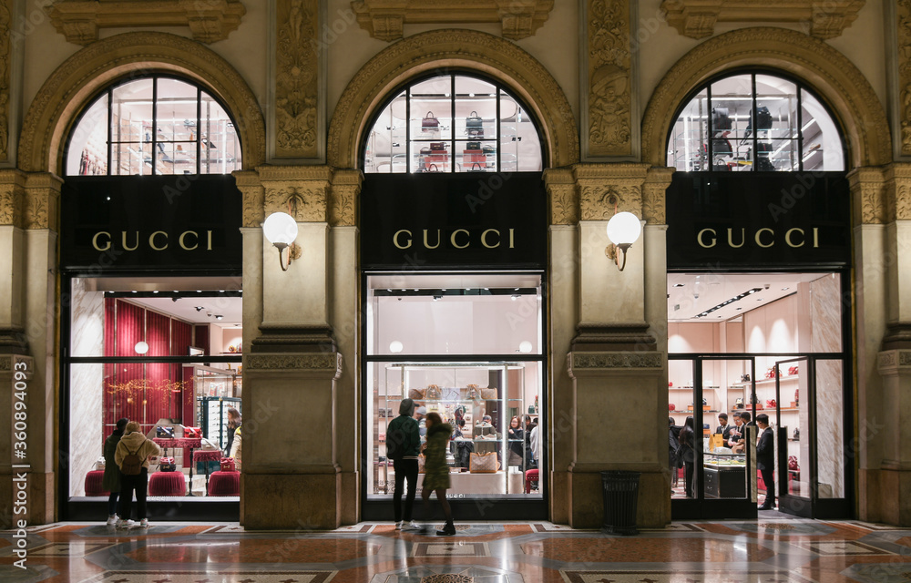 Milan, Italy - January 13, People in front of a Gucci bags and sneakers showcase Stock Photo | Adobe Stock