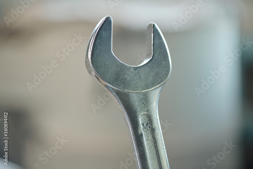 Close-up of metal wrench used to turn bolts and nuts in workshop