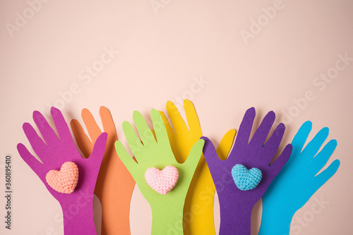 Diversity and people power concept with paper hands and heart shapes