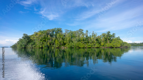 An island of Melanesia is reflected on the mirror of the sea. Munda  Solomon Islands 