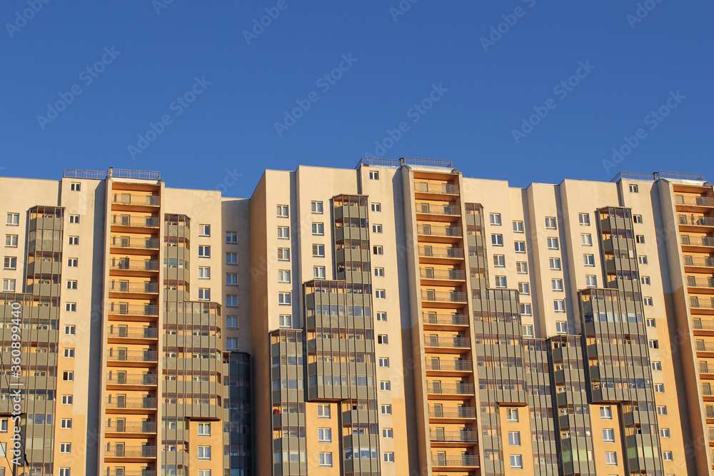modern residential building, building facade on a blue background. New buildings over blue clear cloudless sky