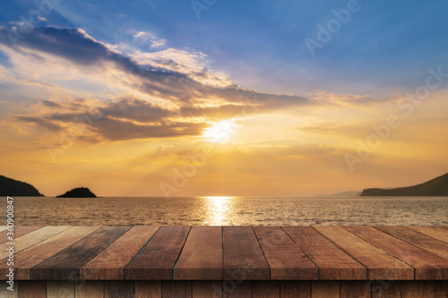 Fototapeta Naklejka Na Ścianę i Meble -  Empty wood table and landscape of sunset on the coast sea, waves with display montage for product.