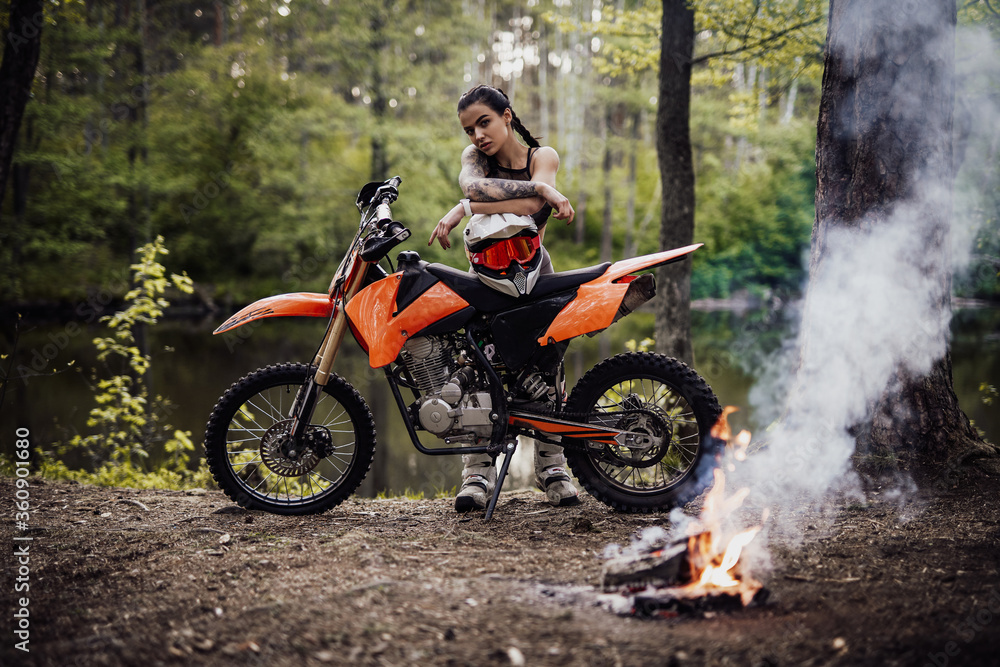Photo Art Print Sensual tattooed racer girl wearing motocross outfit with semi naked torso leani Fxquadro