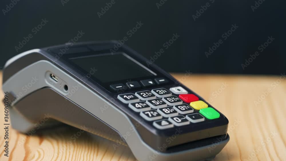 NFC credit card payment. Woman paying with contactless credit card with NFC technology. Wireless money transaction. Wireless payment NFC credit card payment. Woman paying with contactless credit card with NFC technology. Wireless money transaction. Wireless payment