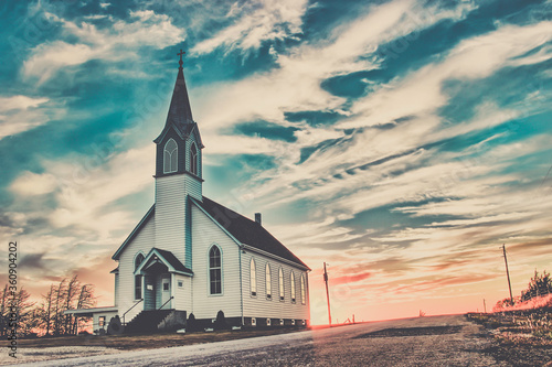 Ellis County, KS, USA - A Lone Wooden Christian Church at Dusk Sunset Skies in the Western Kansas Prairie photo