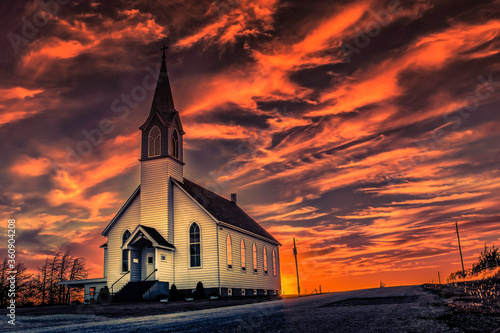 Ellis County, KS, USA - A Lone Wooden Christian Church at Dusk Sunset Skies in the Western Kansas Prairie