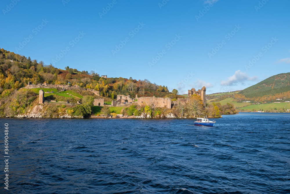 The ruins of a medieval castle on the shores of the legendary Loch Ness lake in autumn