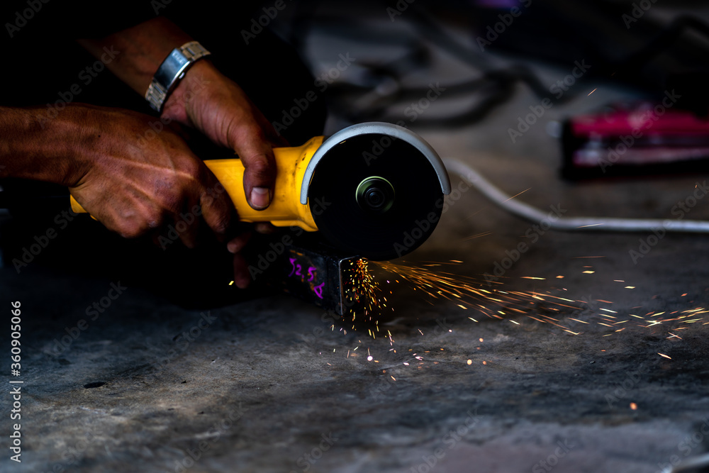Naklejka premium Industrial Worker labourer at the factory welding steel structure