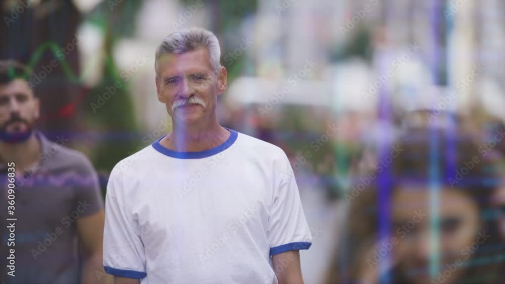 The old smiling man stands on the street on holographic background The old smiling man stands on the street on holographic background