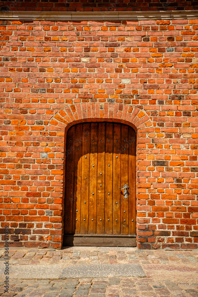 Old wooden gates and walls of red brick. Old wooden gates and walls of red brick.