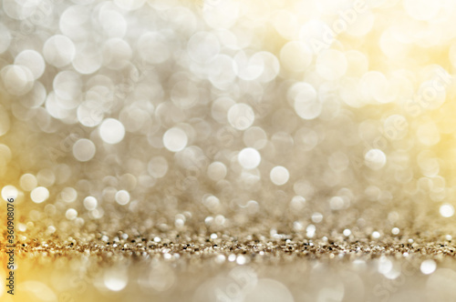 Gold, yellow,brown abstract light background, Golden shining lights, sparkling glittering Christmas lights. Blurred abstract holiday background.
