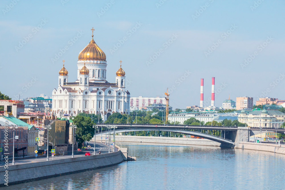 Cityscape of Moscow city on a summer morning with Cathedral of Christ the Saviour in the background. Clear blue sky. Theme of travel in Russia.
