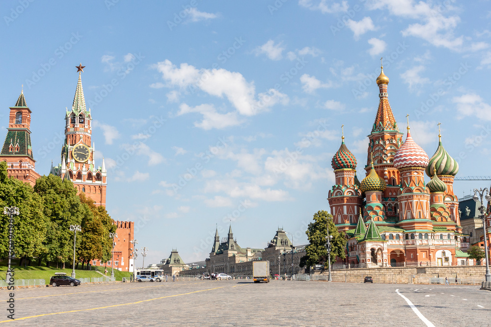 View of Spasskaya Tower of Moscow Kremlin and Saint Basil's Cathedral (or Cathedral of Vasily the Blessed) on Red Square on a summer morning. Theme of travel in Russia. View of Spasskaya Tower of Moscow Kremlin and Saint Basil's Cathedral (or Cathedral of Vasily the Blessed) on Red Square on a summer morning. Theme of travel in Russia.