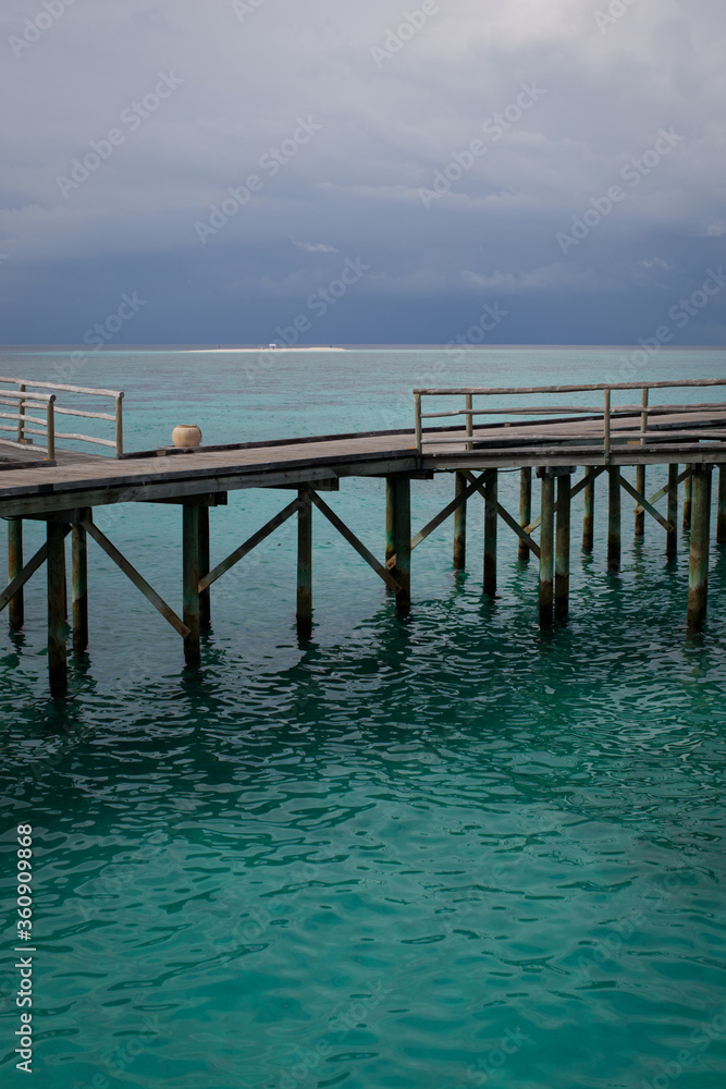 Maldivian jetty seen from turquoise ocean Maldivian jetty seen from turquoise ocean