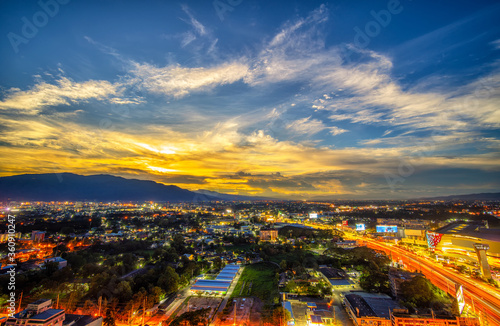 CHIANG MAI, THAILAND - JUNE 28, 2020 : Aerial night view of Chiang Mai Cityscape from a high angle with Doi Suthep and super highway at dusk in Chiang Mai, Thailand © somchairakin