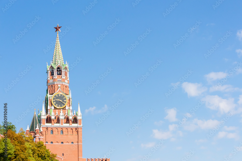 View of Spasskaya Tower of Moscow Kremlin on a summer morning. Blue sky with few clouds in the background. Copy space for your text. View of Spasskaya Tower of Moscow Kremlin on a summer morning. Blue sky with few clouds in the background. Copy space for your text.