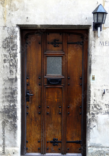 An old wooden door in Painswick town, Cotswolds, England, UK.  photo