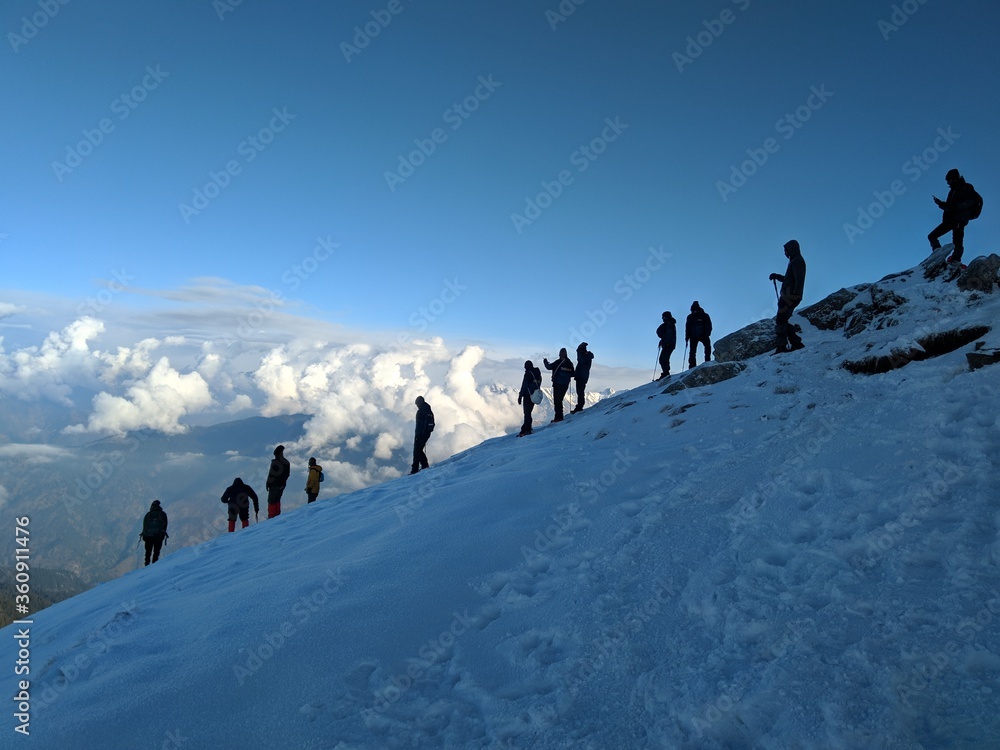 A group hiking down a peak at 3815 metres. - obrazy, fototapety, plakaty 