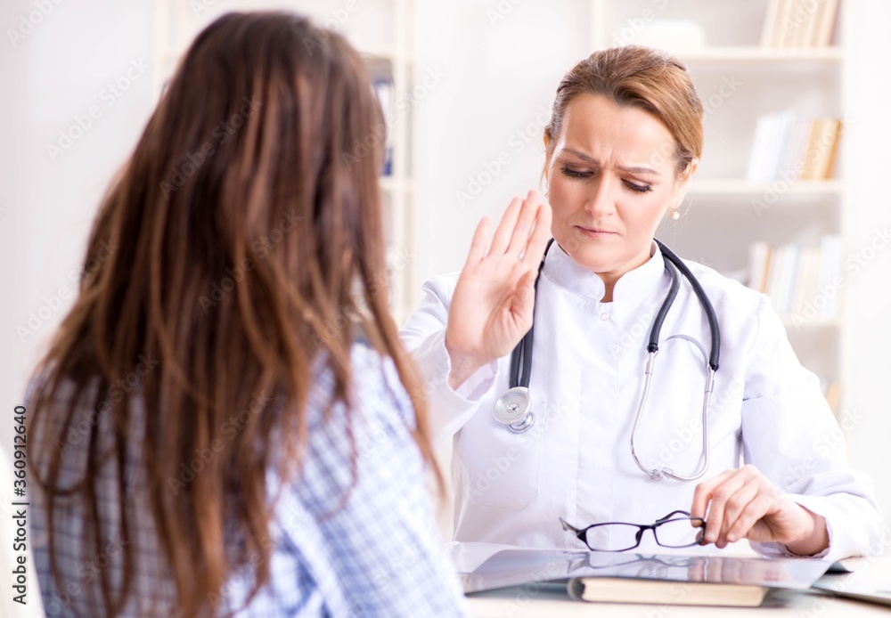 Pregnant woman visiting doctor for regular check-up Pregnant woman visiting doctor for regular check-up