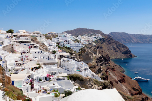 View of the white-walled houses characteristic of Santorini Island nestled along the cliff, Oia, Santorini, Cyclades Islands, Greece