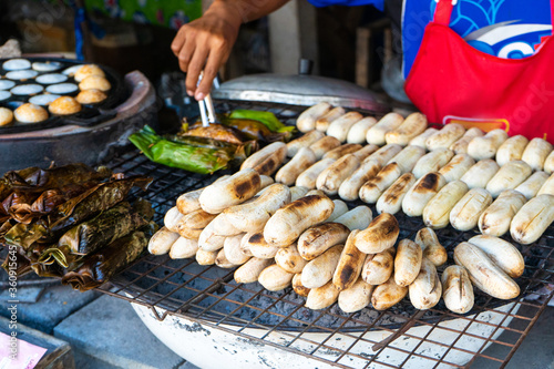 A street food vendor in Asia sells fried bananas and other snacks.