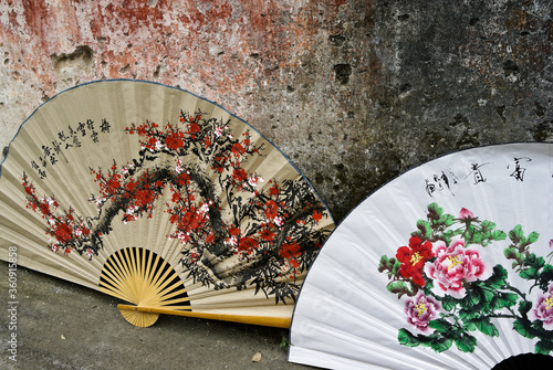 Photography Large, hand-painted, decorative fans for sale outside a shop in Fuli, Guangxi Pr