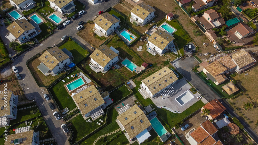 Aerial view of the Villa in Campofelice di Roccella in Sicily, under a beautiful sunny sky, with swimming pools and trees. Aerial view of the Villa in Campofelice di Roccella in Sicily, under a beautiful sunny sky, with swimming pools and trees.