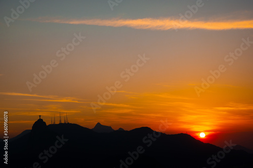 Sunset, right side, corcovado and mountains in silhouette with blue and red sky seen from Niteroi, Rio de Janeiro, Brazil