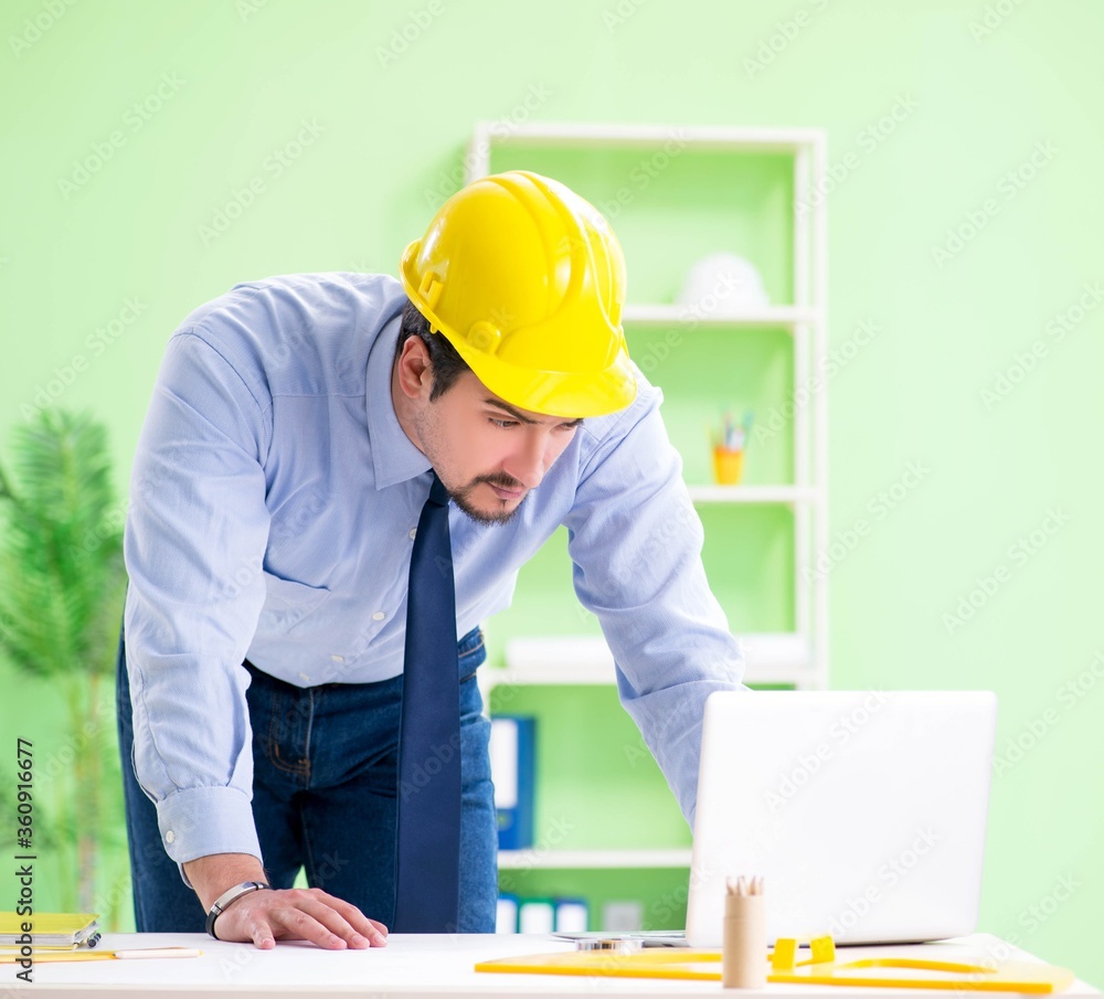 Young male architect working at the project Young male architect working at the project