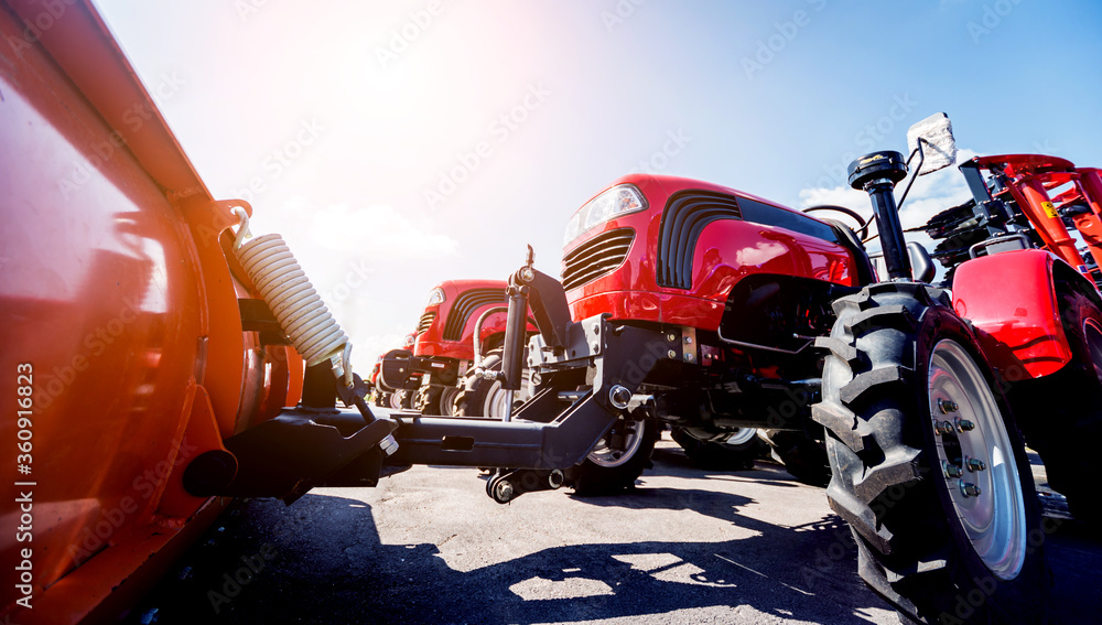 Obraz premium Rows of modern tractors. Industrial details. Agricultural 