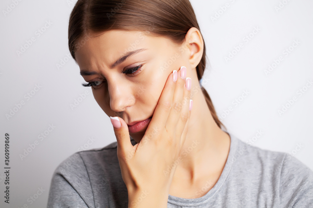 Exhausted young woman suffering from severe toothache Exhausted young woman suffering from severe toothache