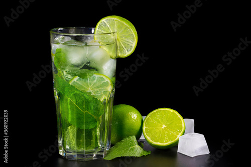 Refreshing summer alcoholic cocktail mojito with ice  fresh mint and lime on dark background.