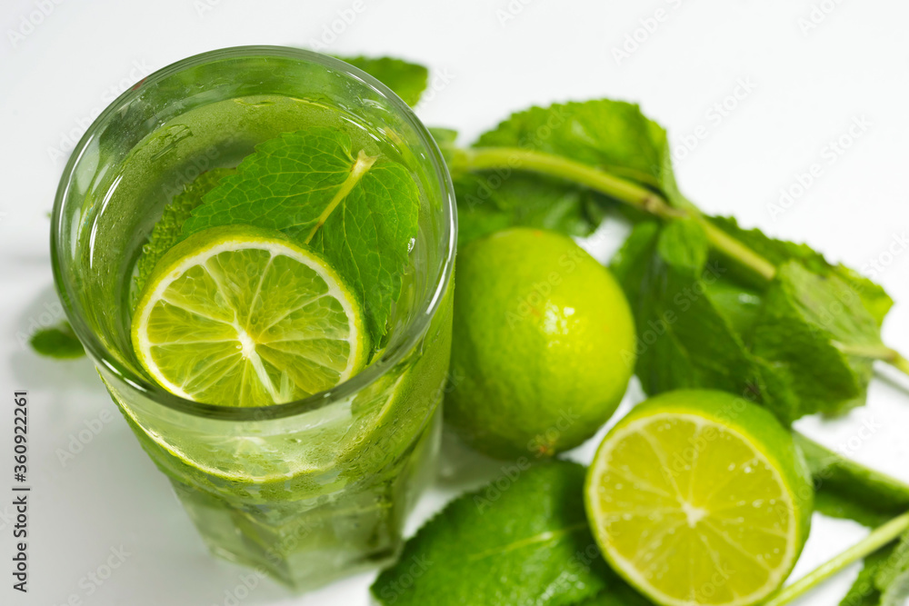 Mojito cocktail with ice, fresh mint and lime on a dark background, close-up. Mojito cocktail with ice, fresh mint and lime on a dark background, close-up.