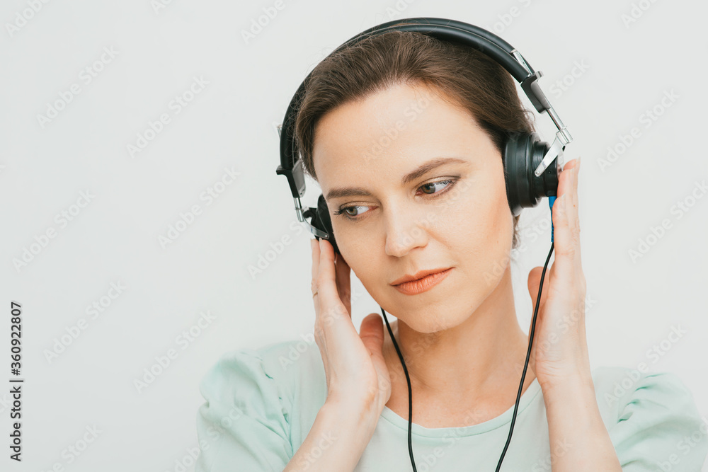 Hearing test, hearing diagnostic. A woman wearing headphones having an audiometry test isolated in white