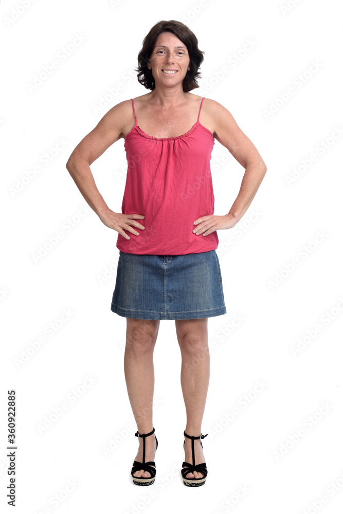 woman in a denim skirt on white background, hands on hip woman in a denim skirt on white background, hands on hip