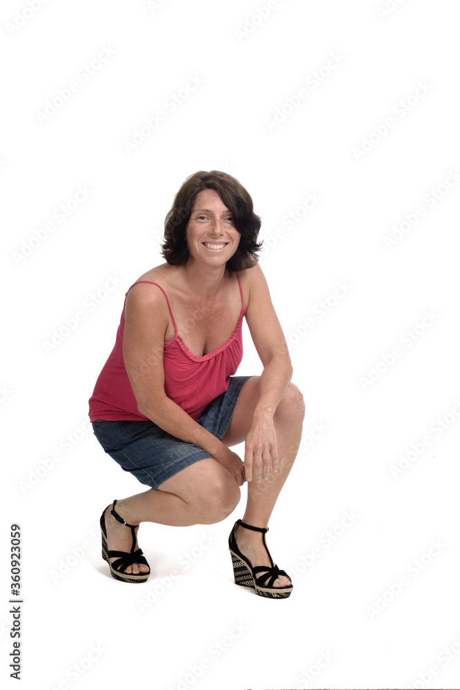 woman squatting with denim skirt on white background, woman squatting with denim skirt on white background,