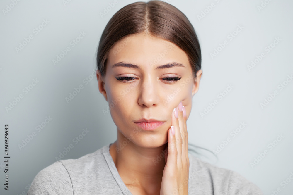Exhausted young woman suffering from severe toothache Exhausted young woman suffering from severe toothache